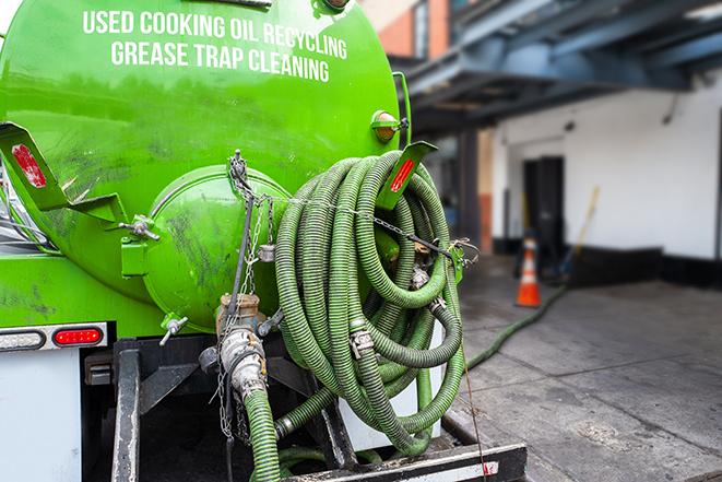 pump truck removing waste from a grease trap in Bayside